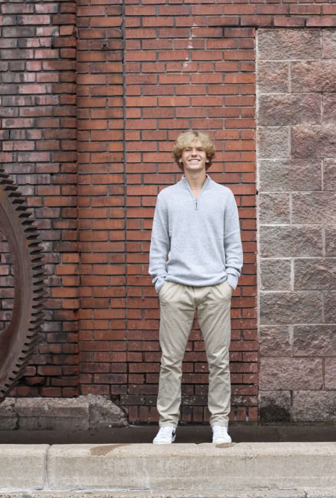 Photo of Presley Clay who is a Digital Professional growing his digital marketing Portfolio posing for his senior pictures.